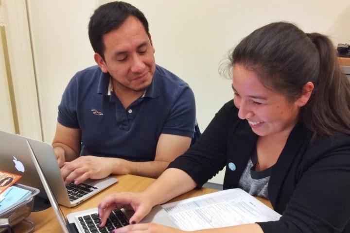 Thesis Reviewer working with student on computer